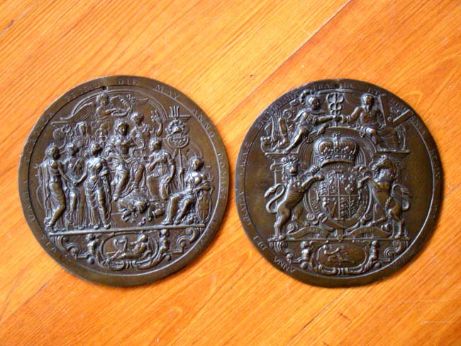 A fine and rare pair of historically important Queen Anne period cast bronze medallions dated 1707.